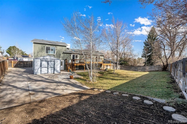 back of house with a wooden deck, a lawn, a fenced backyard, stairs, and an outdoor structure