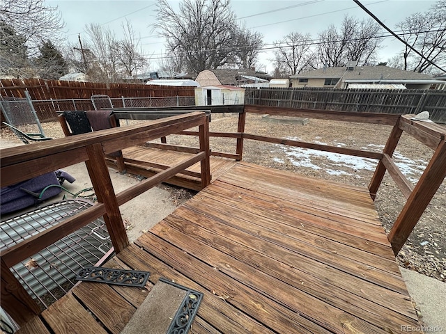 wooden terrace featuring a storage unit