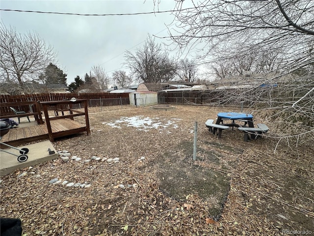 view of yard with a storage shed and a deck