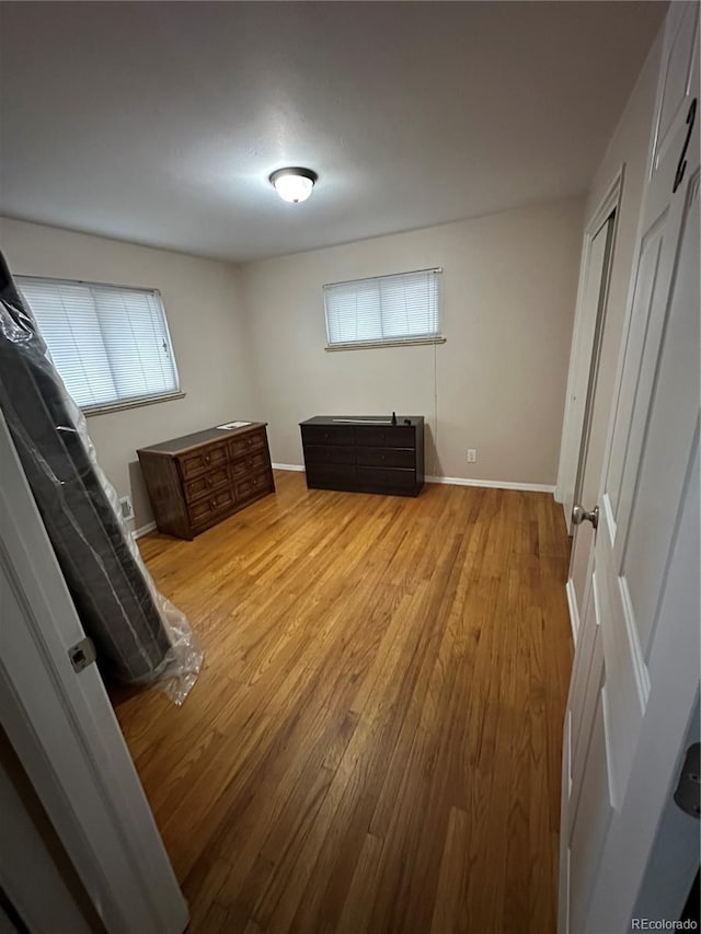 bedroom featuring light wood-type flooring and multiple windows