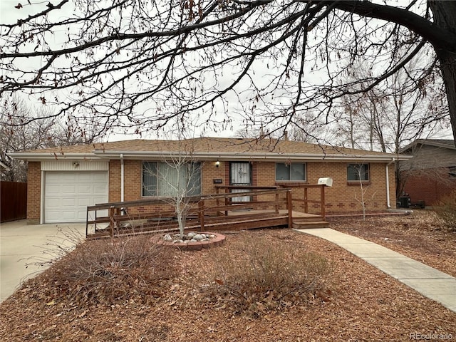 single story home featuring a garage and cooling unit