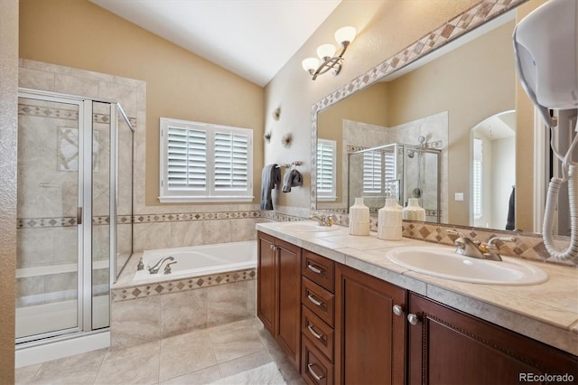 bathroom featuring lofted ceiling, a wealth of natural light, a sink, and a stall shower