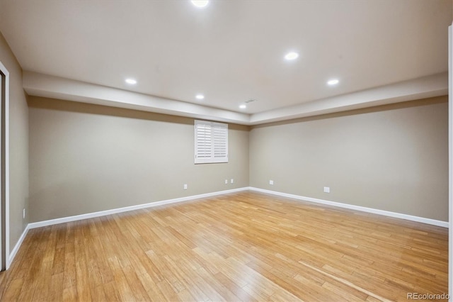 empty room featuring baseboards, recessed lighting, and light wood-style floors