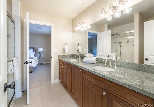 bathroom featuring tile patterned flooring, vanity, and walk in shower