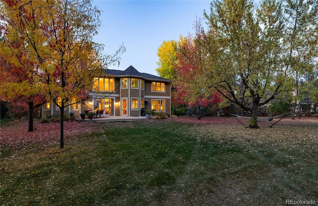 back of house featuring a lawn