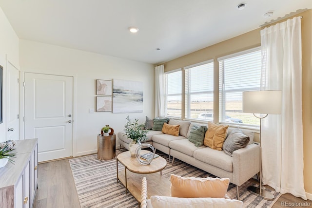 living room featuring light wood-type flooring and baseboards