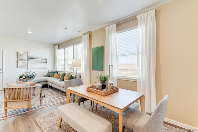 dining room with light wood finished floors and baseboards