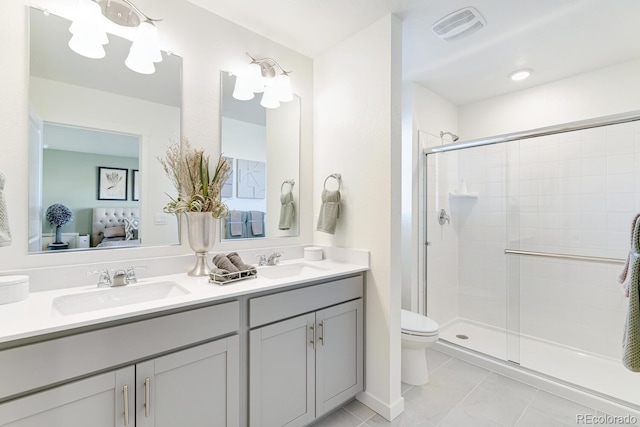 bathroom featuring ensuite bathroom, a stall shower, a sink, and visible vents