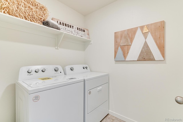 laundry room with laundry area, washing machine and clothes dryer, and baseboards