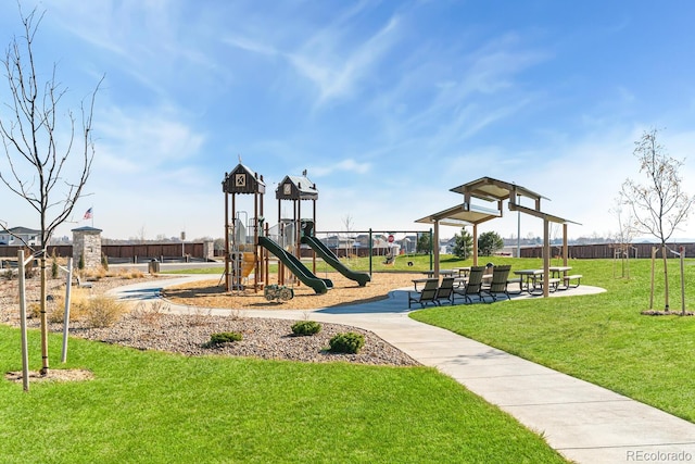 community play area with a yard and fence