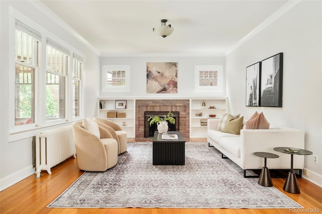 730 Cook St, Denver, CO 80206 - sitting room featuring radiator heating unit, ornamental molding, wood finished floors, baseboards, and a brick fireplace