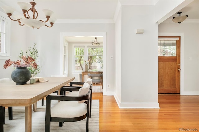 730 Cook St, Denver, CO 80206 - dining space with a chandelier, light wood-type flooring, baseboards, and crown molding