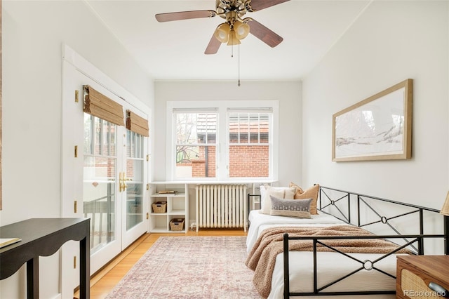 730 Cook St, Denver, CO 80206 - bedroom with radiator heating unit, light wood-style flooring, access to outside, and french doors