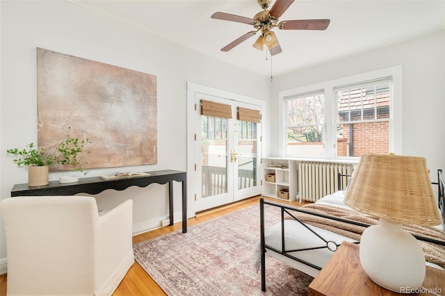730 Cook St, Denver, CO 80206 - sitting room featuring radiator heating unit, wood finished floors, french doors, and a ceiling fan