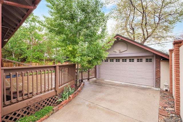 730 Cook St, Denver, CO 80206 - view of front of home with an outbuilding, a garage, a deck, brick siding, and driveway