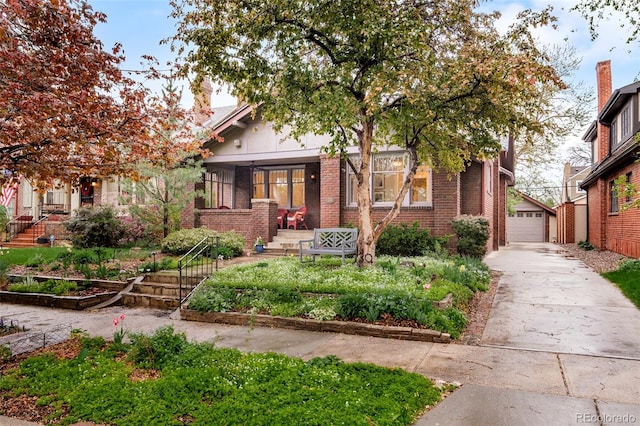 730 Cook St, Denver, CO 80206 - view of front of house featuring brick siding, an outdoor structure, and a detached garage