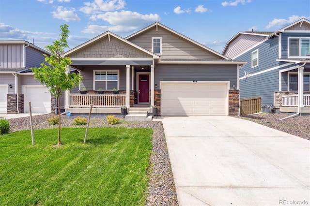 920 London Way, Severance, CO 80550 - craftsman inspired home with stone siding, covered porch, concrete driveway, a garage, and a front yard