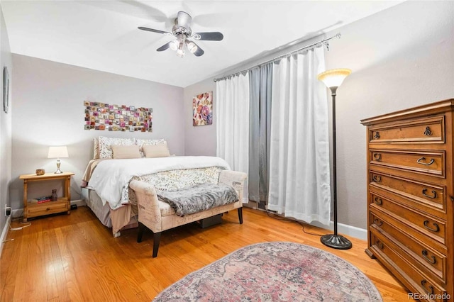 bedroom with hardwood / wood-style flooring and ceiling fan