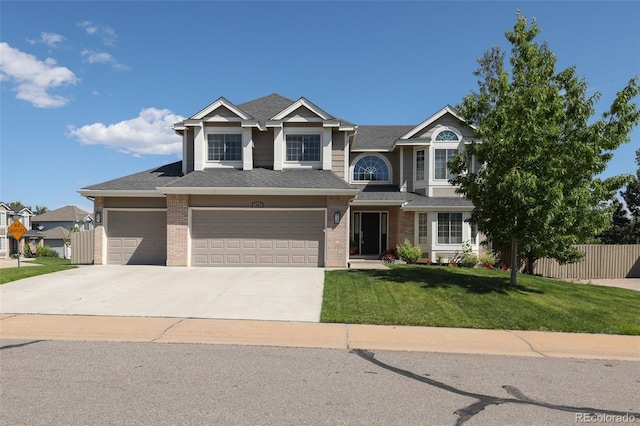 1881 Alma Ln, Superior, CO 80027 - view of front facade with brick siding, driveway, an attached garage, and roof with shingles