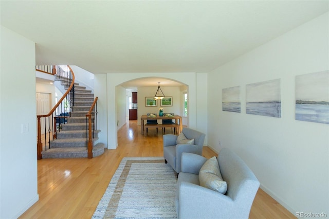 1881 Alma Ln, Superior, CO 80027 - living area featuring arched walkways, light wood-type flooring, and stairs