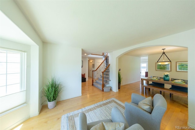 1881 Alma Ln, Superior, CO 80027 - living room with arched walkways, wood finished floors, and stairs