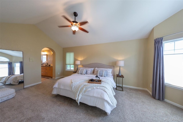 1881 Alma Ln, Superior, CO 80027 - bedroom featuring vaulted ceiling, arched walkways, light carpet, multiple windows, and a ceiling fan