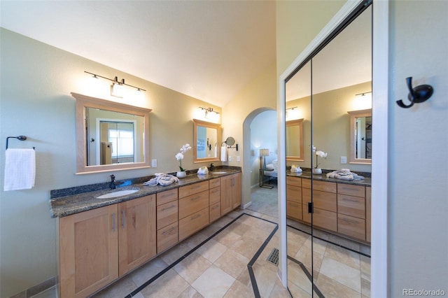 1881 Alma Ln, Superior, CO 80027 - bathroom with double vanity, tile patterned floors, inlaid floor details, and lofted ceiling