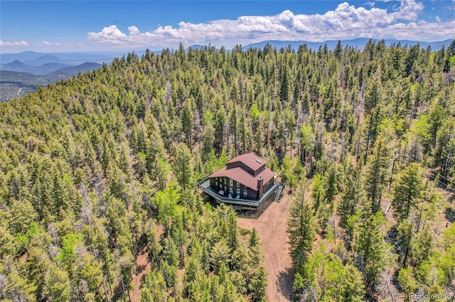 11333 Conifer Mountain Rd, Conifer, CO 80433 - aerial view of property and surrounding area featuring a heavily wooded area and a mountainous background