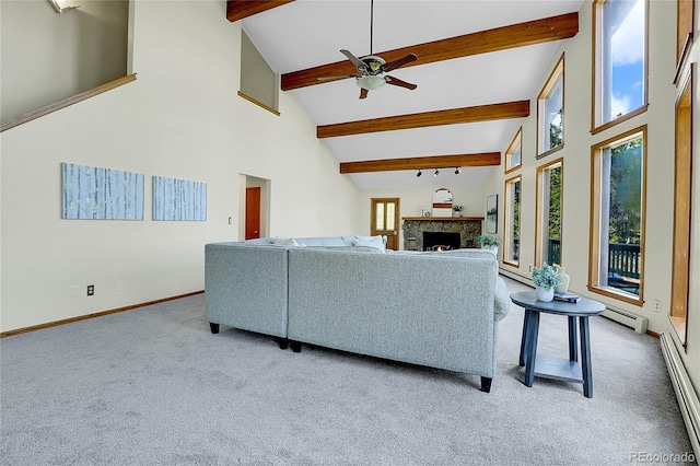 11333 Conifer Mountain Rd, Conifer, CO 80433 - living room featuring carpet floors, a stone fireplace, a ceiling fan, beamed ceiling, and a baseboard heating unit