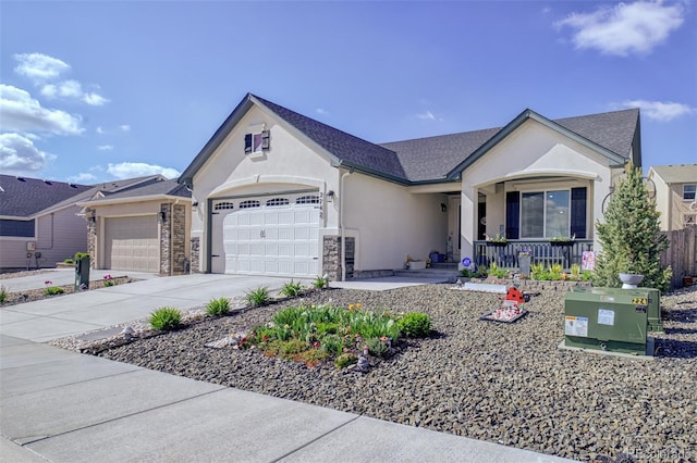 2742 Show Hunter Way, Colorado Springs, CO 80922 - view of front of house featuring an attached garage, concrete driveway, stucco siding, covered porch, and stone siding
