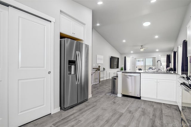 2742 Show Hunter Way, Colorado Springs, CO 80922 - kitchen with stainless steel appliances, a peninsula, lofted ceiling, a ceiling fan, and white cabinetry