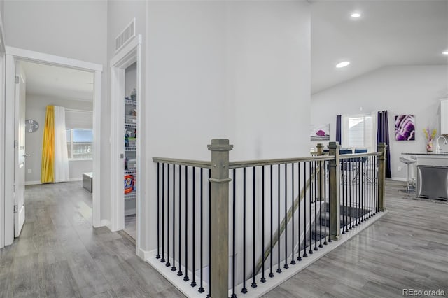 2742 Show Hunter Way, Colorado Springs, CO 80922 - corridor featuring an upstairs landing, wood finished floors, lofted ceiling, recessed lighting, and baseboards