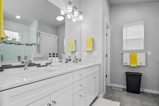 2742 Show Hunter Way, Colorado Springs, CO 80922 - full bathroom featuring double vanity, baseboards, and a stall shower