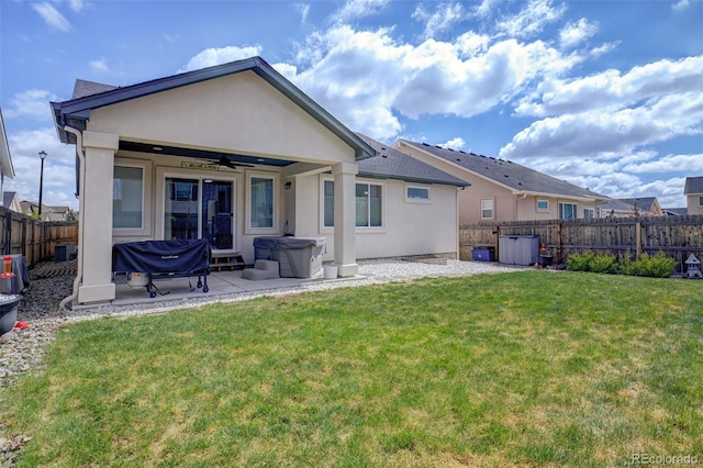 2742 Show Hunter Way, Colorado Springs, CO 80922 - rear view of house featuring a hot tub, a ceiling fan, stucco siding, and a patio area