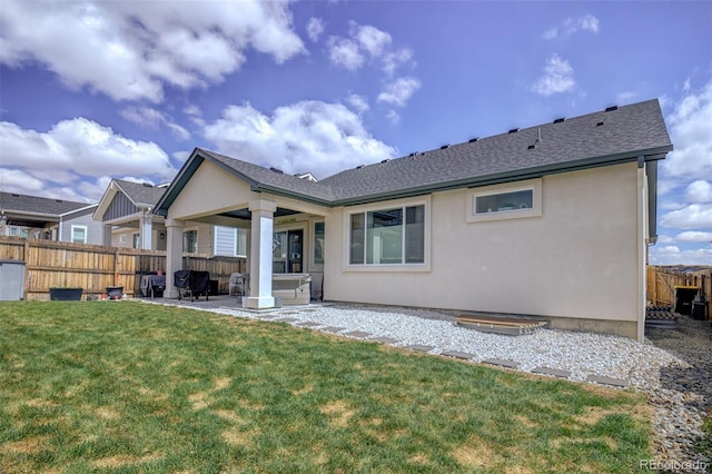 2742 Show Hunter Way, Colorado Springs, CO 80922 - back of property featuring a patio area, stucco siding, a shingled roof, and a hot tub