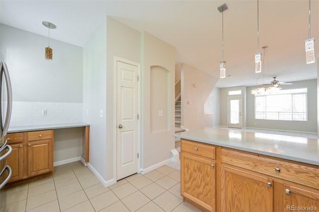 kitchen with tasteful backsplash, pendant lighting, light tile patterned floors, and light countertops