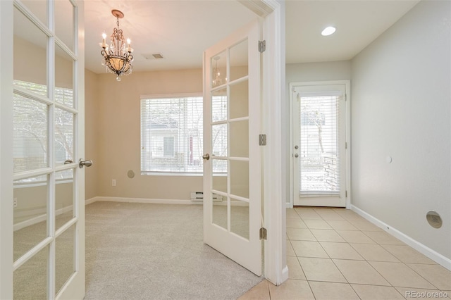 interior space with a chandelier, a wealth of natural light, french doors, and baseboard heating