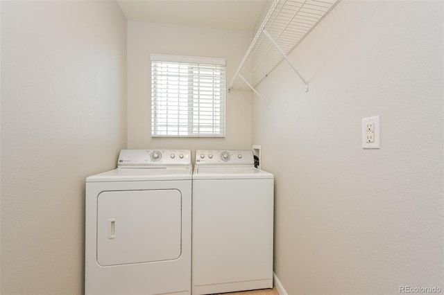 clothes washing area with washer and dryer and laundry area