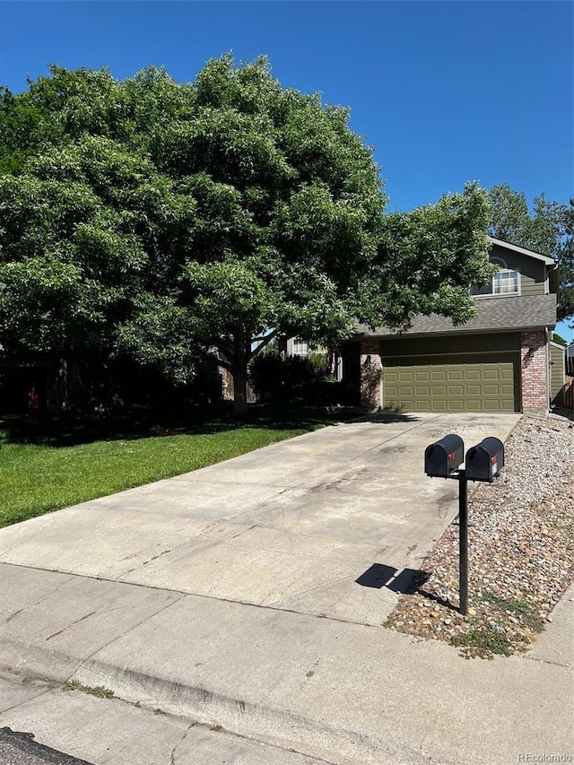 5201 E 127th Dr, Thornton, CO 80241 - view of property hidden behind natural elements with concrete driveway and brick siding