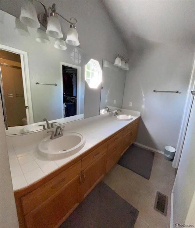 5201 E 127th Dr, Thornton, CO 80241 - full bathroom featuring double vanity, tile patterned floors, and lofted ceiling