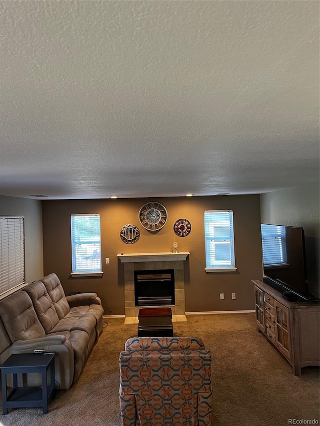 5201 E 127th Dr, Thornton, CO 80241 - carpeted living room featuring a textured ceiling, healthy amount of natural light, and a tile fireplace