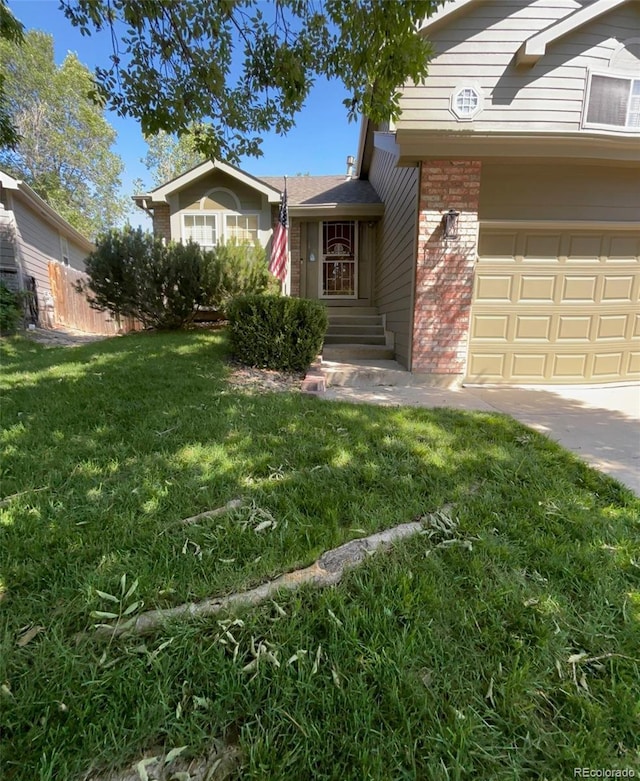 5201 E 127th Dr, Thornton, CO 80241 - view of front facade with brick siding and an attached garage
