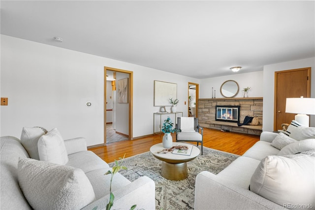 7135 S Sherman St, Centennial, CO 80122 - living room featuring wood finished floors and a stone fireplace