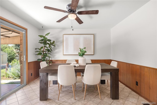 7135 S Sherman St, Centennial, CO 80122 - dining room with wainscoting, wood walls, ceiling fan, and light tile patterned floors