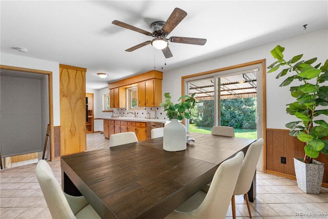 7135 S Sherman St, Centennial, CO 80122 - dining room featuring light tile patterned flooring, ceiling fan, a wainscoted wall, and wooden walls