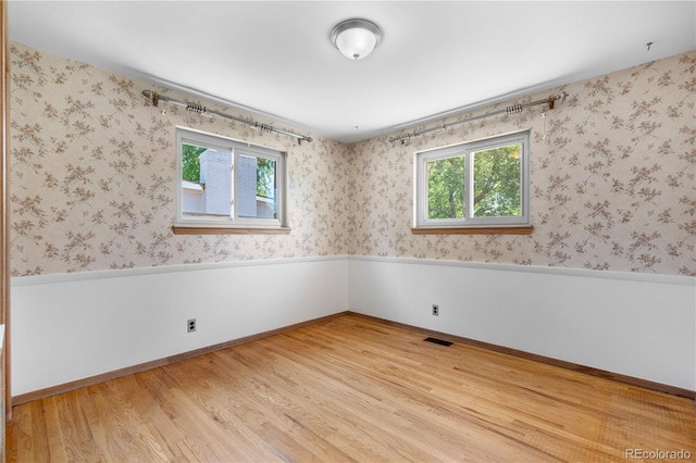 7135 S Sherman St, Centennial, CO 80122 - unfurnished room featuring plenty of natural light, light wood-style flooring, and wainscoting