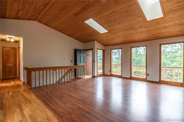 917 Bluebird Ln, Bailey, CO 80421 - spare room with a skylight, vaulted ceiling, wood finished floors, wood ceiling, and baseboards