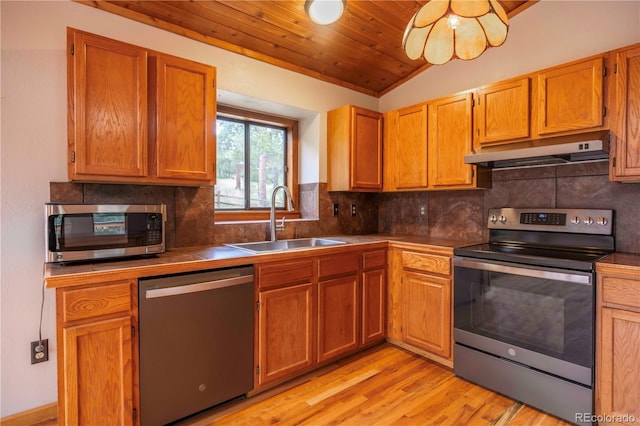 917 Bluebird Ln, Bailey, CO 80421 - kitchen featuring appliances with stainless steel finishes, under cabinet range hood, a sink, tile counters, and lofted ceiling