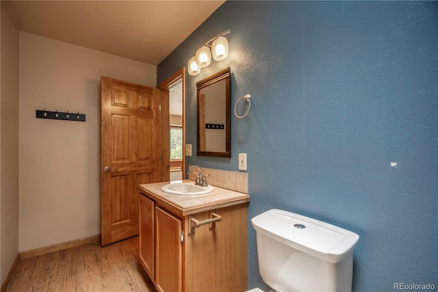 917 Bluebird Ln, Bailey, CO 80421 - bathroom featuring vanity, wood finished floors, toilet, and baseboards