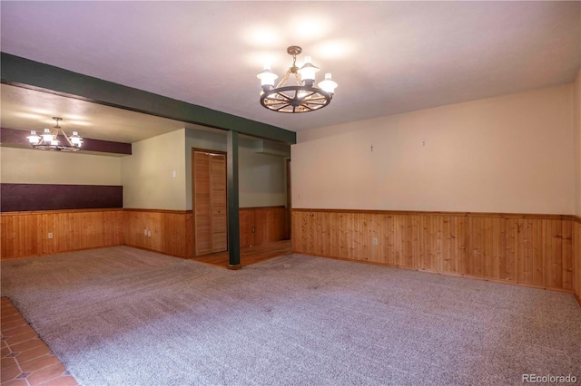 917 Bluebird Ln, Bailey, CO 80421 - empty room with a chandelier, wainscoting, wooden walls, and carpet